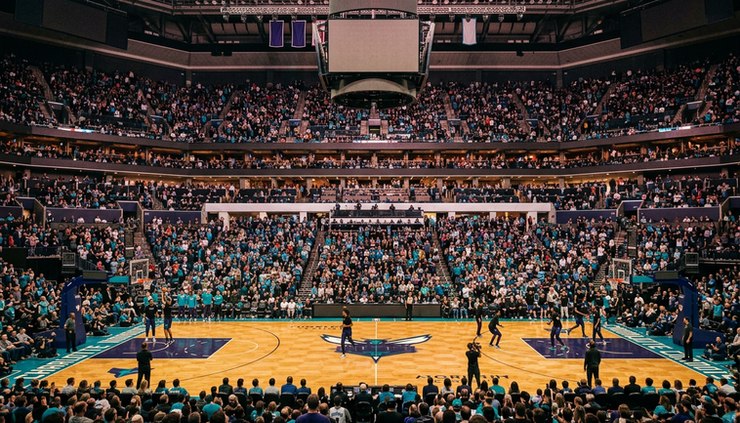 Wide-angle view of a packed Charlotte basketball arena before tipoff