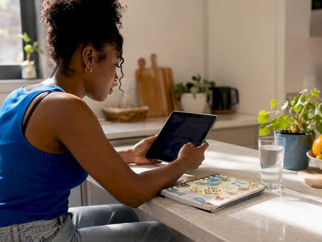 Woman checking ticket prices at home on tablet
