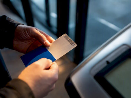 Buyer inspecting ticket beside entry scanner
