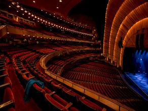 Tiered theater seating viewed toward the stage