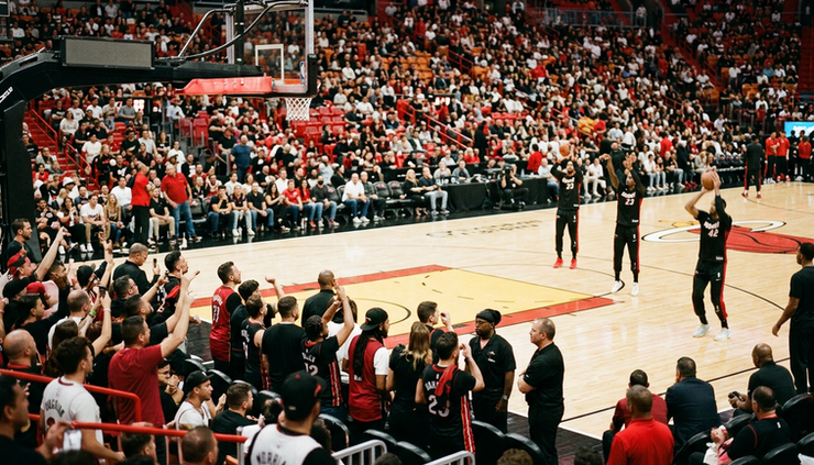 Eye-level view from a lower bowl corner seat at a basketball game