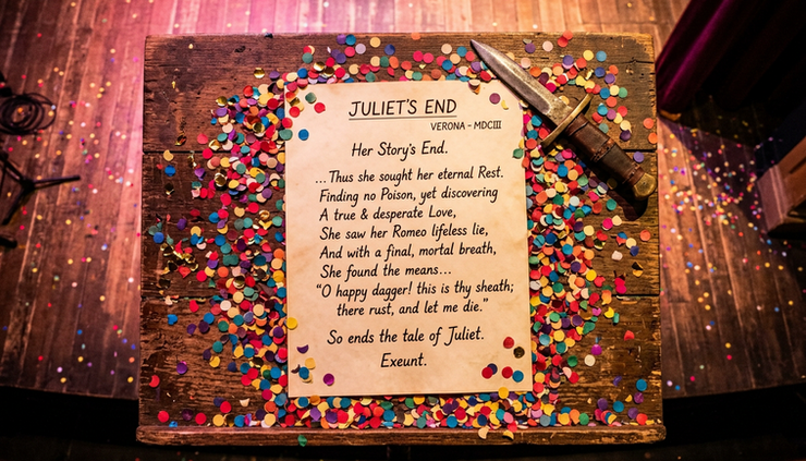 Overhead view of colorful theater confetti surrounding a rewritten final page of Juliet’s story.