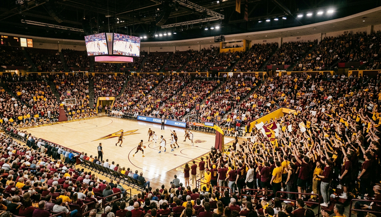 Wide-angle view of a college basketball arena in Tempe filled with maroon and gold fans.