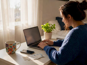 Woman securing concert tickets online at home desk