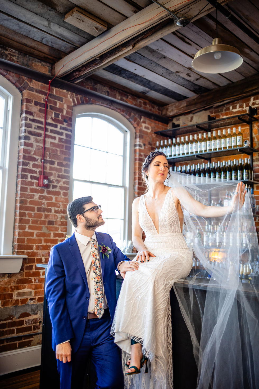wedding couple posing in bar at wedding venue