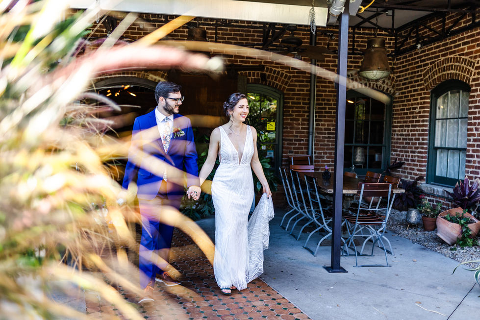 wedding couple smiling and walking hand in hand