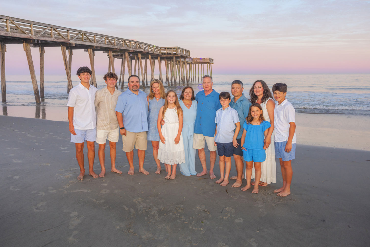 family beach portrait session in front of the ocean city nj fishing pier