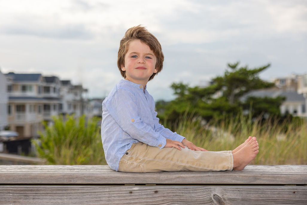Candid photography of children playing on the beach in LBI NJ during a sunset portrait session.
