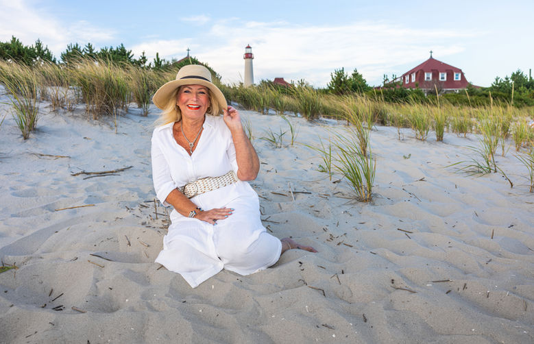 a well dressed woman out for a beach portrait session in the dunes of cape may point nj