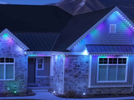 Home with Jellyfish permanent LED lighting installed along the roofline displaying colorful programmable exterior lighting.