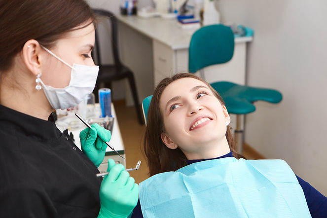 beautiful_positive_young_woman_smiling_broadly_after_regular_dental.jpg