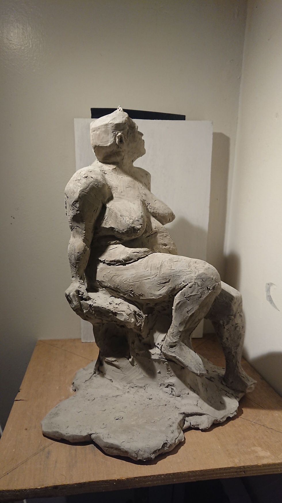 Female figure sculpted from clay turn around