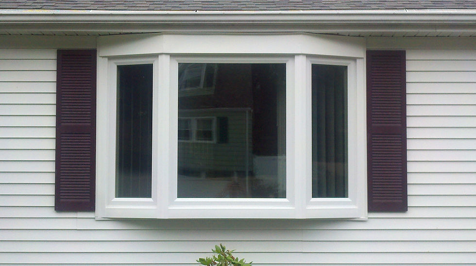 Windows project photo, white bay window with shutters on light siding