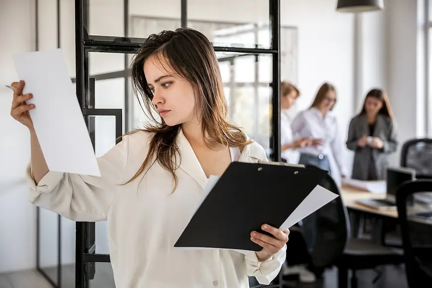 front-view-female-office-checking-plans.webp