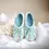 Thumbnail: Front view light blue alpaca felt slippers with silk and embroidery detail on front.