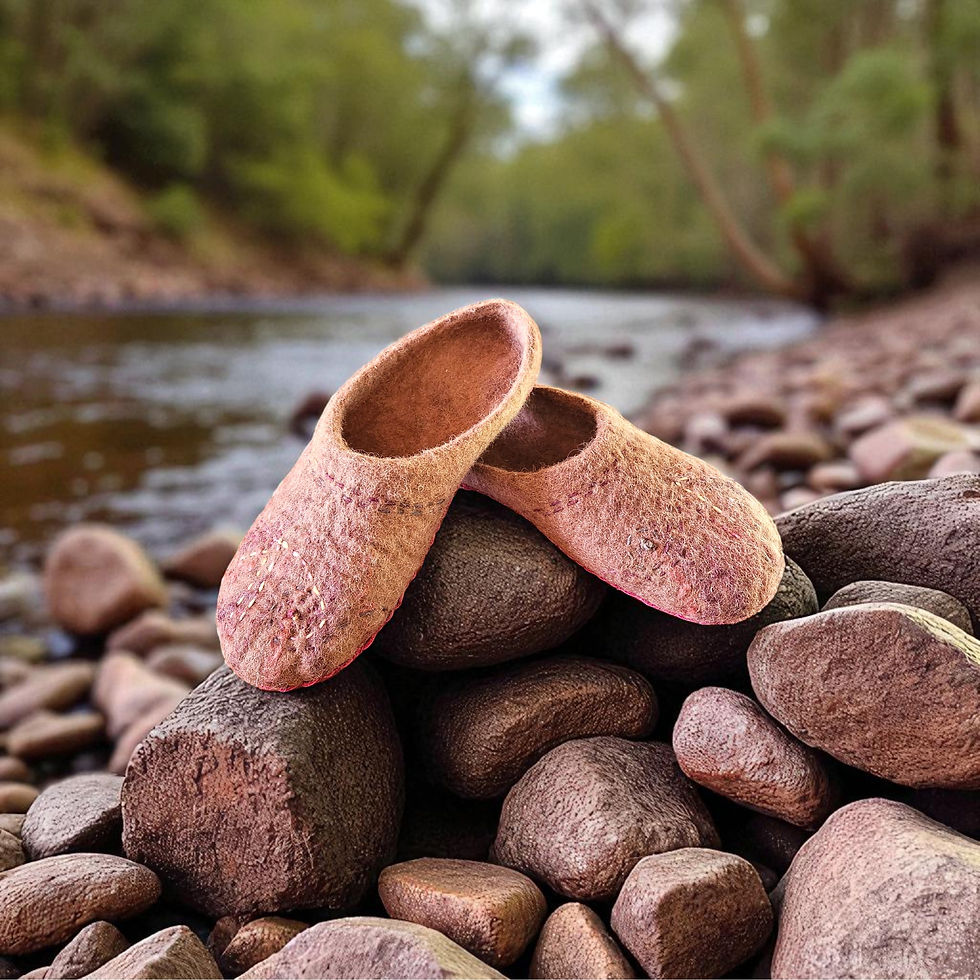 Thumbnail: A pair of brown toned alpaca low rise mules on some brown rocks next to a creek.