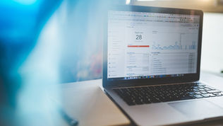 Laptop displaying Google Analytics in a modern workspace, highlighting digital analytics and technology.
