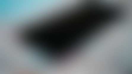 Close-up of a smartphone placed on a detailed road map of Poland, emphasizing travel and technology.