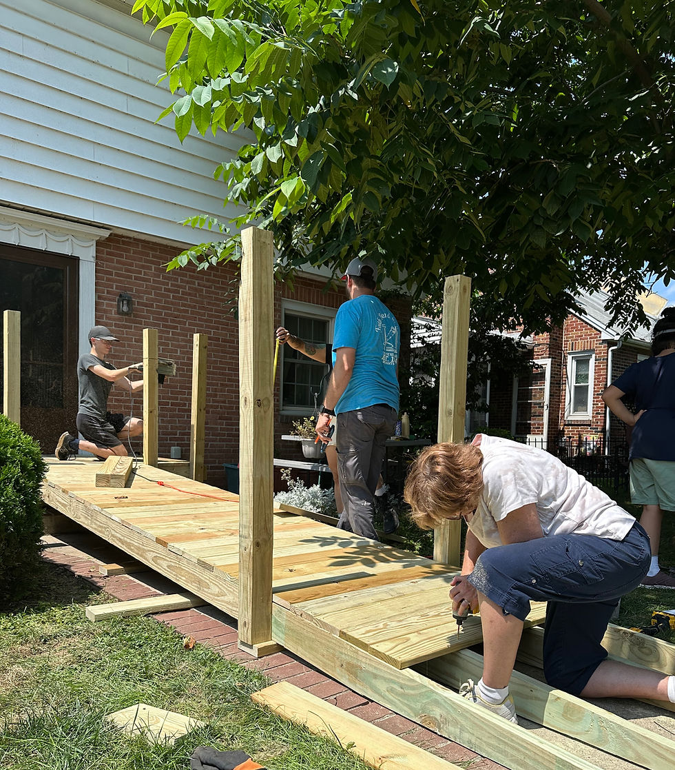 People building a wooden accessibility ramp