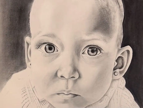 A photorealistic drawing of a baby looking at the viewer. Textures in the drawing have been rendered with a variety of markmaking, from soft linework on the fabric, shiny highlights on an earring in the baby's ear, and smooth value transitions across the face