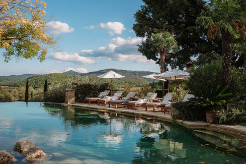 Panoramic infinity pool at Borgo Santo Pietro overlooking the Tuscan hills