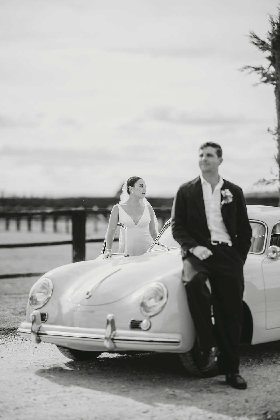 Couple portrait leaning on vintage Porsche at Il Borro Tuscany wedding photography