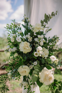 Close-up of white roses and greenery in the ceremony decoration at Il Borro Tuscany.