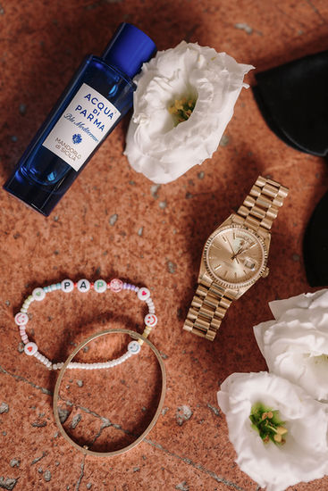 Groom accessories with perfume and gold watch