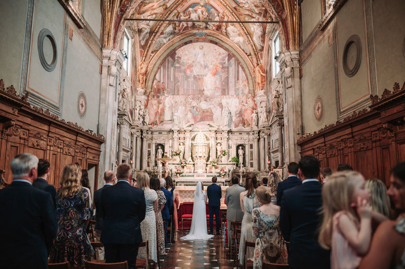 Bride and groom at the altar, guests observing Alyssa and Sean’s elopement at Belmond Villa San Michele Florence.