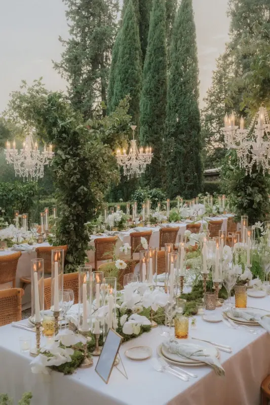 outdoor wedding reception in Tuscany with greenery and candlelight atmosphere
