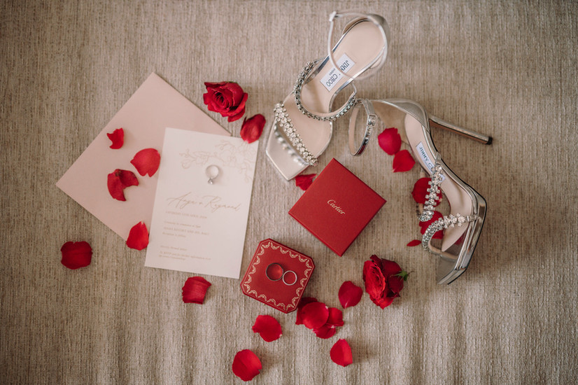 Wedding invitation and rings with silver heels and rose petals, riccardopieri