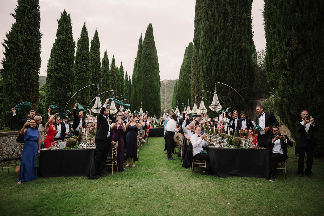 Wedding reception between cypress trees at Villa Cetinale at dusk, Tuscany