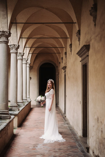 Bride in white dress holding bouquet, Alyssa and Sean elopement at Belmond Villa San Michele Florence.
