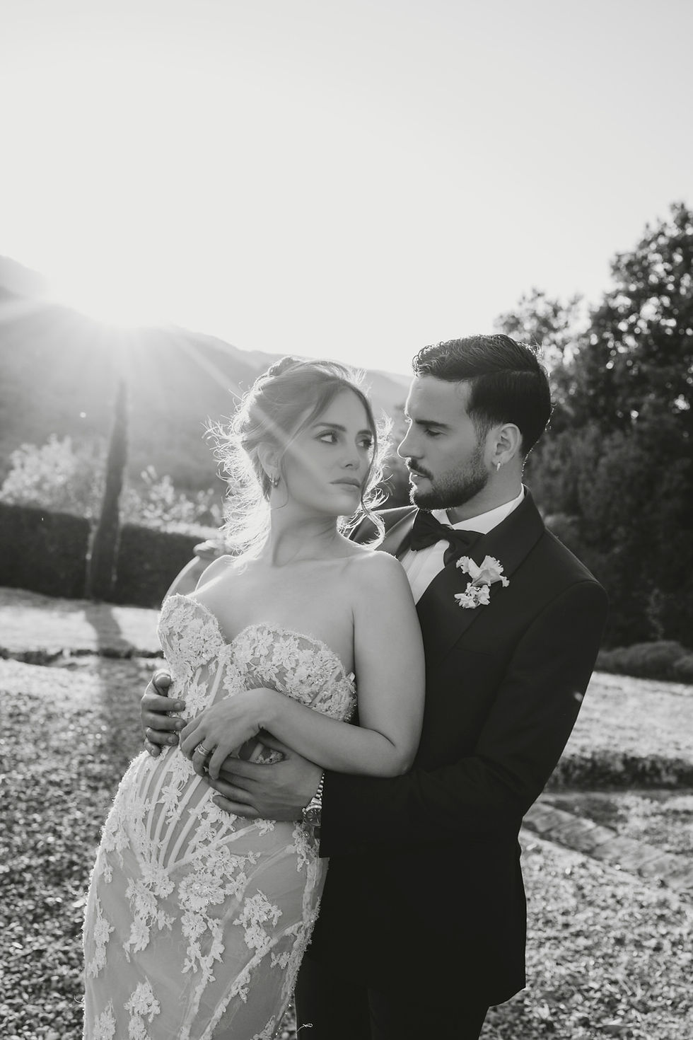 Bride and groom embracing at sunset during an elegant destination wedding in Italy