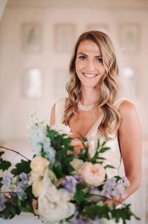 Smiling bride holding flowers, elegant wedding at Conti di San Bonifacio, portrait photo, riccardopieri