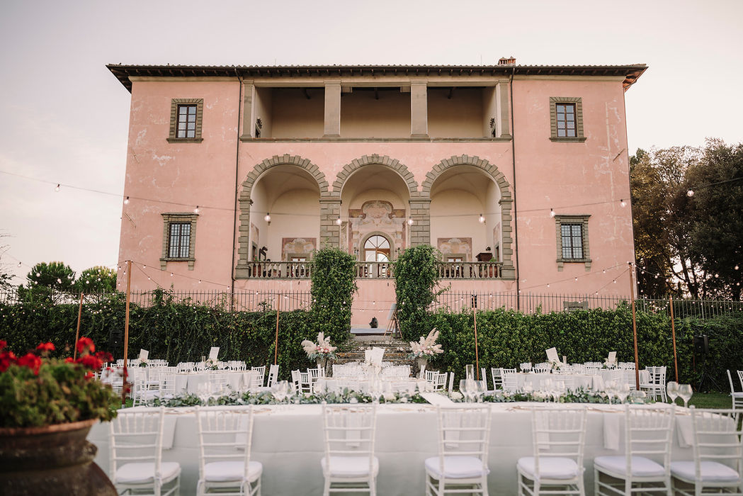 Wedding reception setup in front of Villa Mangiacane with elegant tables in Tuscany