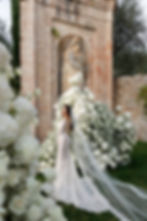 bride portrait with white floral installation at elegant Tuscan wedding venue
