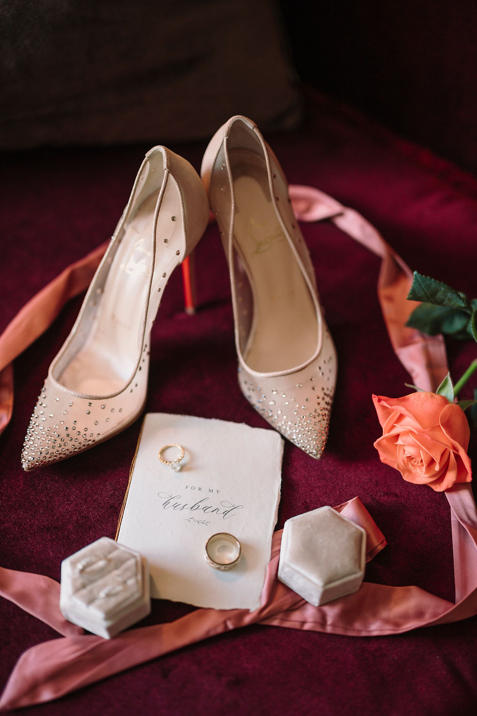 Elegant bridal heels with wedding rings and soft blush styling details.