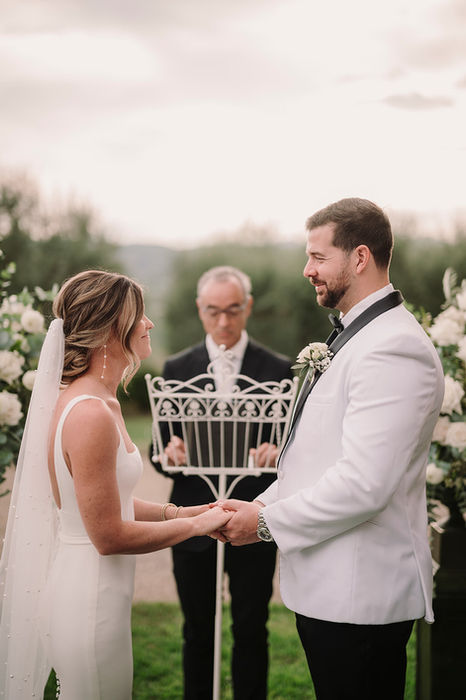 Bride and groom exchanging vows at outdoor ceremony, Villa Petrea Tuscany wedding