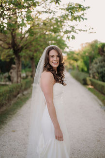 Outdoor bridal portrait along the tree lined path at Borgo Santo Pietro