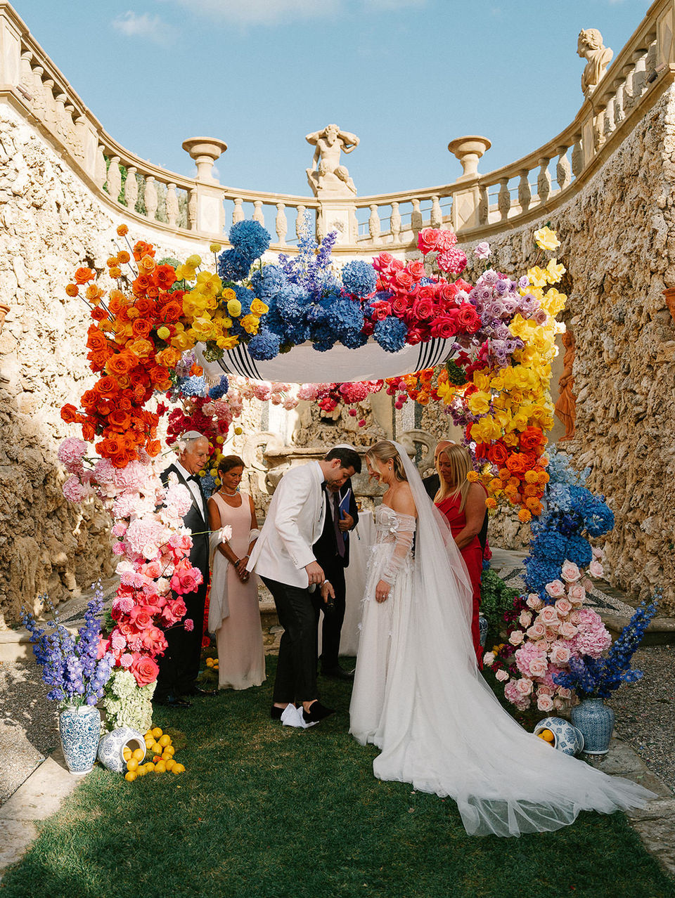 colorful floral ceremony arch for destination wedding in Tuscan