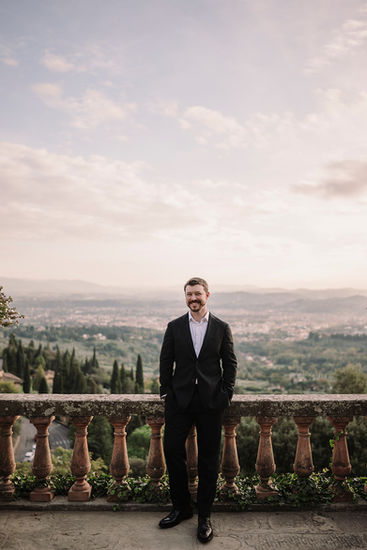 Man in suit smiles. Mountains background elopement at Belmond Villa San Michele Florence riccardopieri