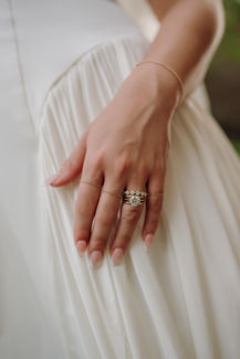 Close-up of the bride’s engagement and wedding rings.