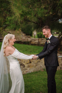 Bride and groom laugh, holding hands, celebrating their wedding day. Jessica and Liam – A Joyful Tuscan Wedding.
