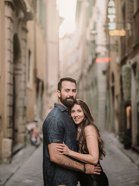 Couple embracing in a historic Florence alley at sunset