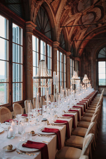 Elegant dinner setup in Tuscan villa with long tables