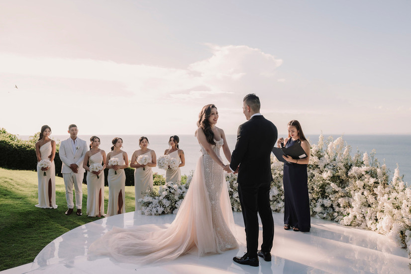 Bride and groom holding hands, with bridesmaids, luxury wedding at Ayana Resort Bali.