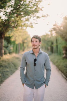Man stands on path; trees behind him. riccardopieri elopement at Belmond Villa San Michele Florence