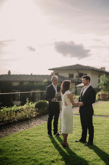 Couple exchanging vows, officiant present. Alyssa and Sean – Elegant elopement at Belmond Villa San Michele Florence.