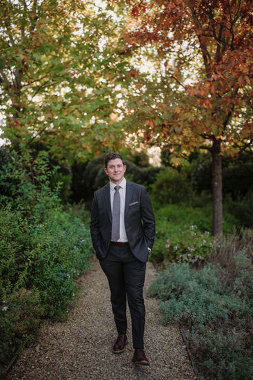 Groom portrait in the garden with autumn foliage and natural light
